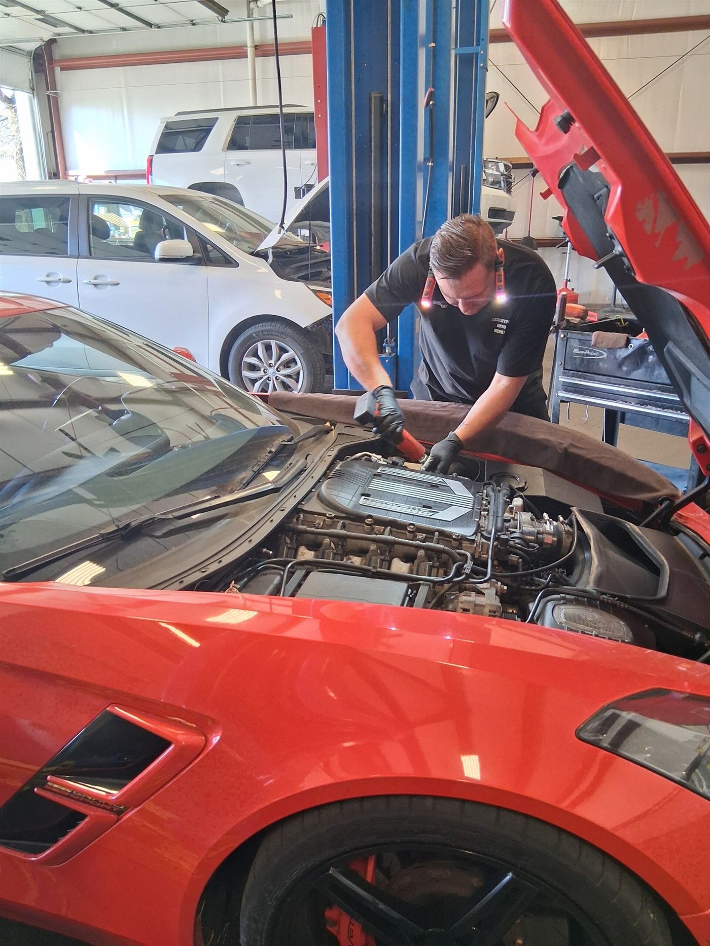 Executive Auto technician performing engine work on a sports car in Owensboro, KY