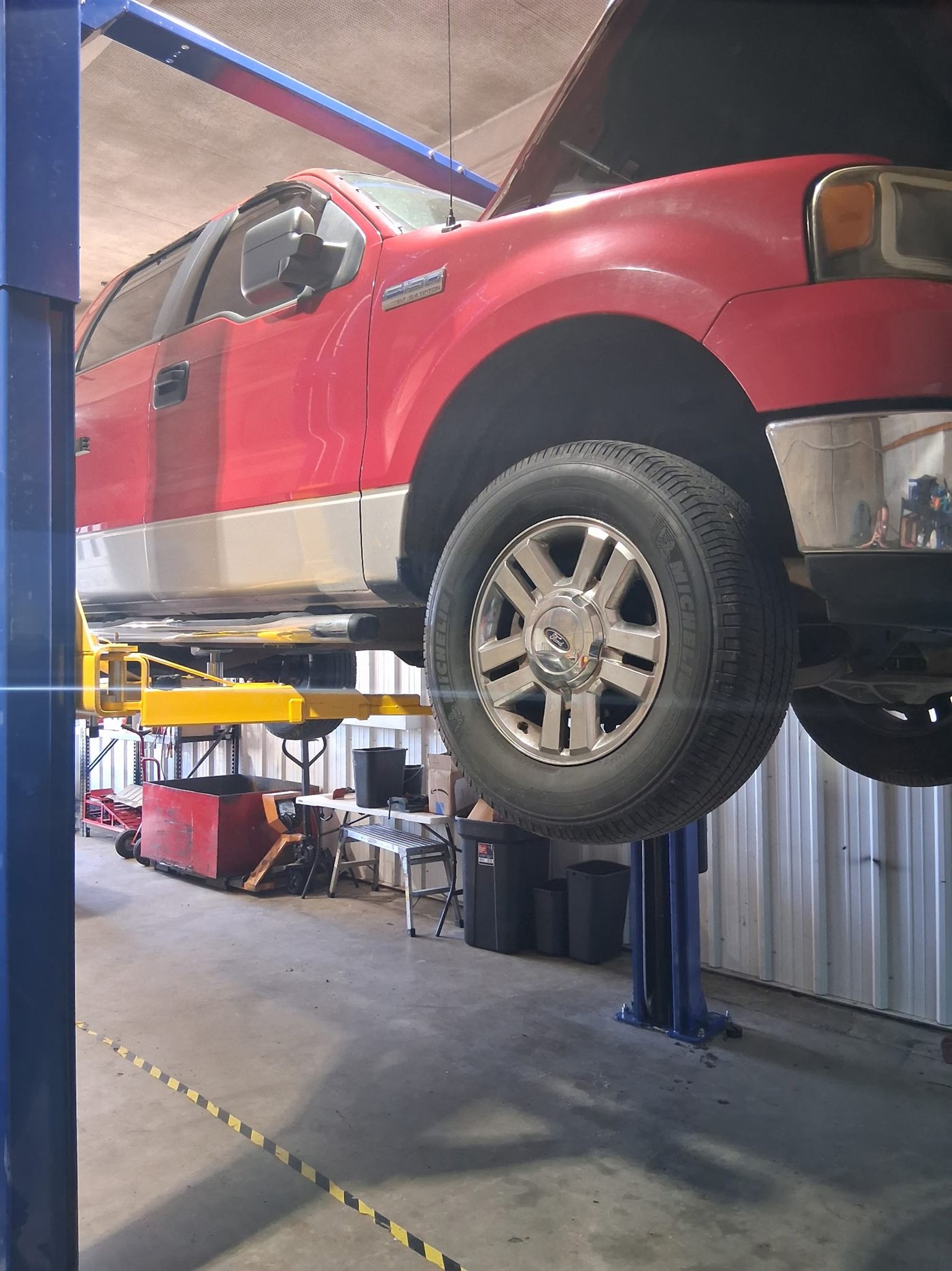 Vehicle on the lift for suspension work at Executive Auto in Owensboro, KY